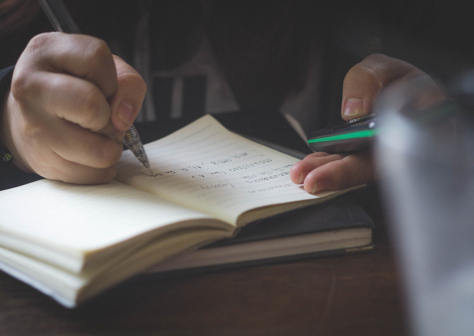 Young person writing in notebook