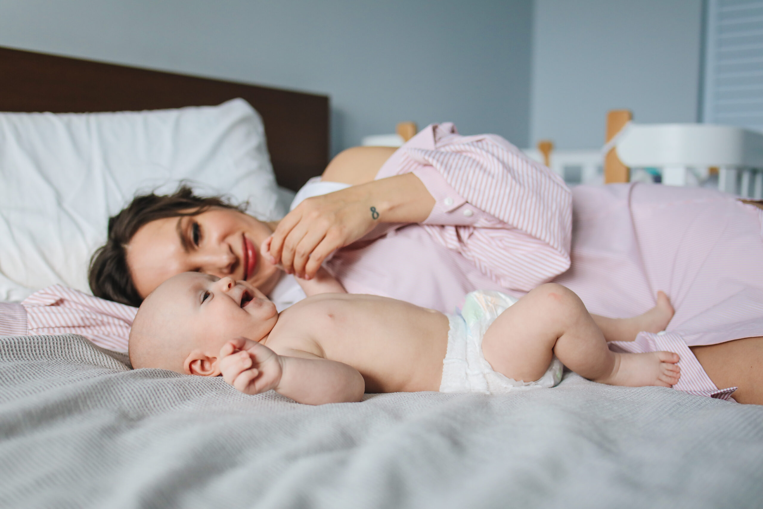 Mother lying in bed with child