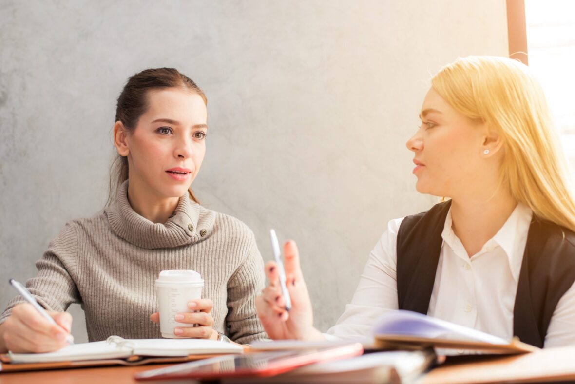 Two women discussing work
