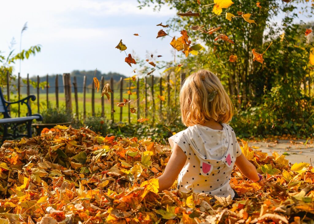 Girl sitting in leaves