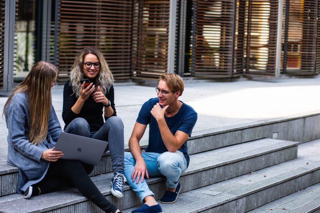 Three young people talking outside