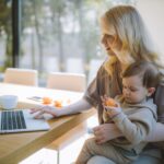 Woman on a laptop with child
