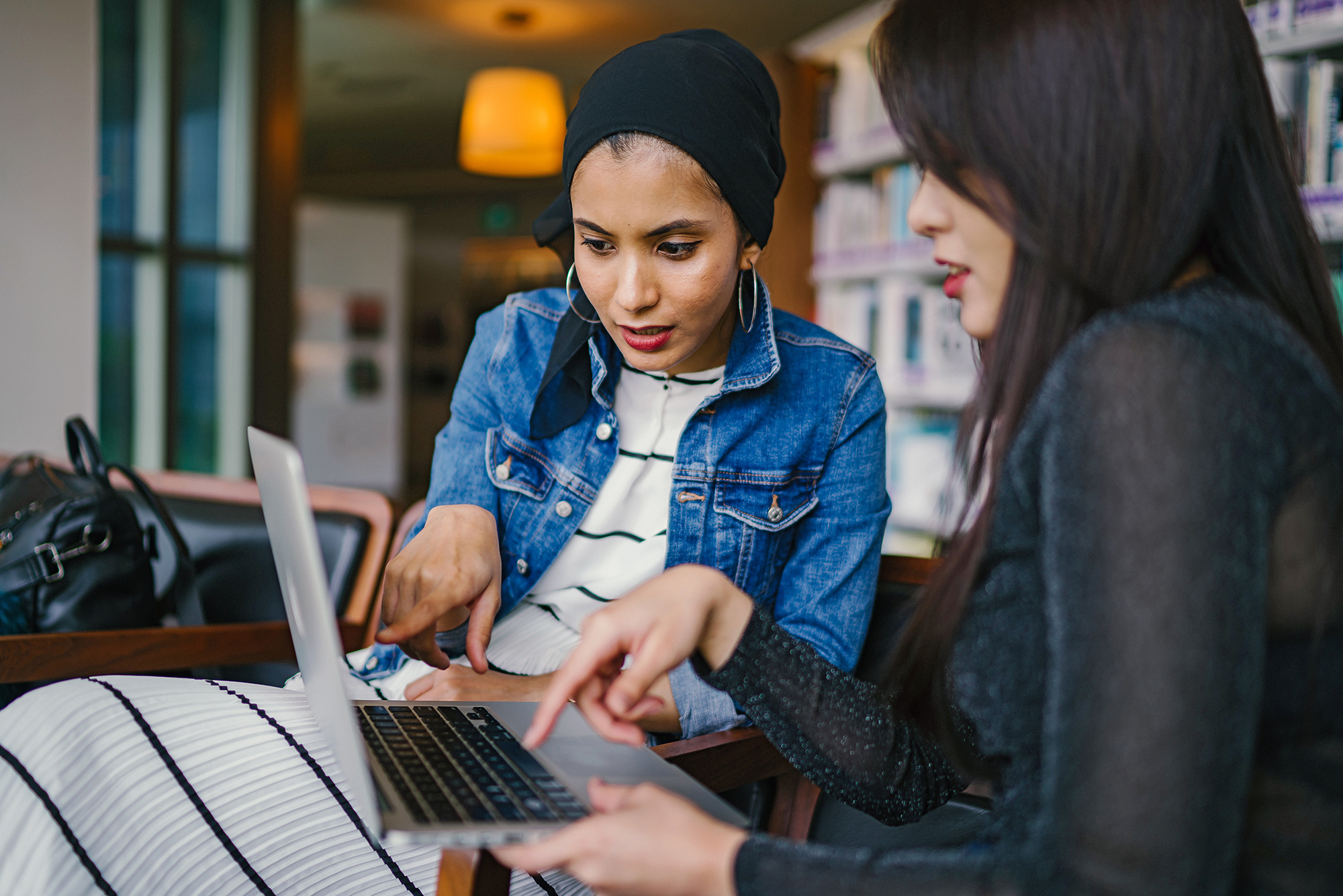 Two women looking at a laptop