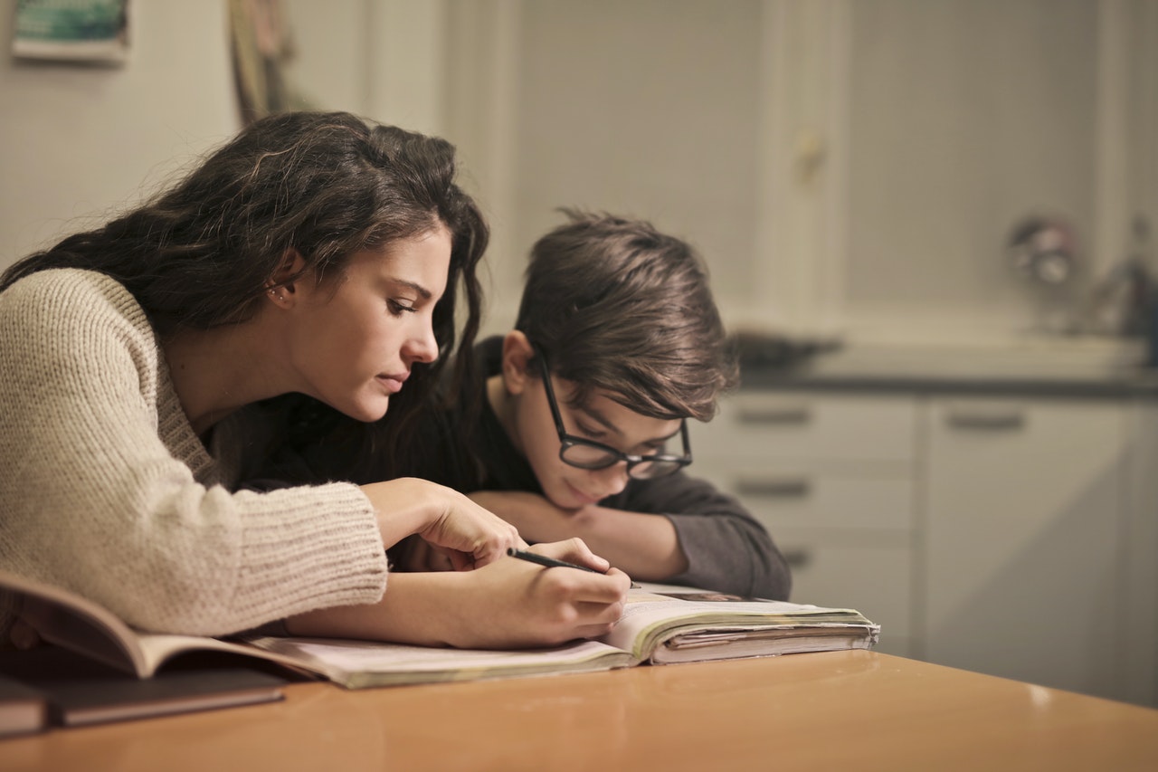 Mother helping child study