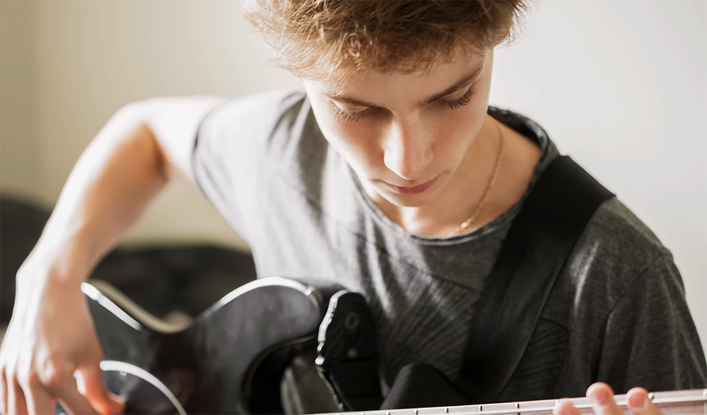 Young person playing guitar