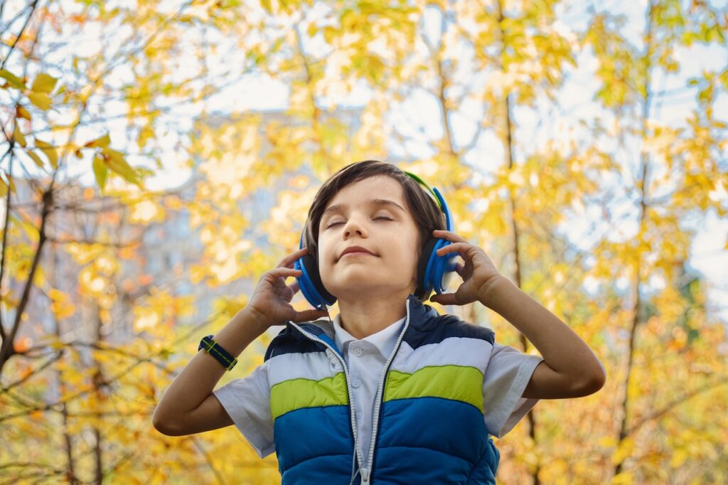 Child with headphones walking