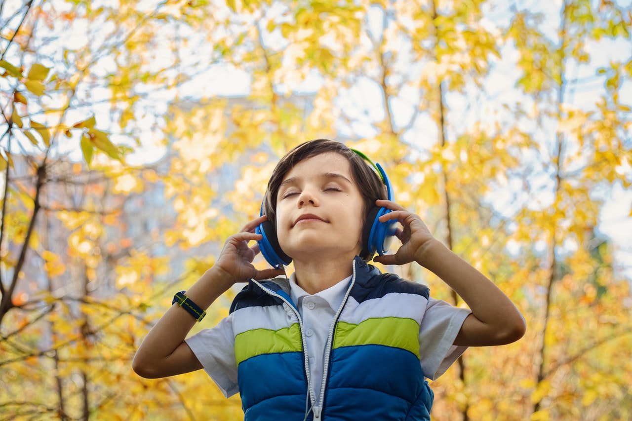 Child with headphones walking