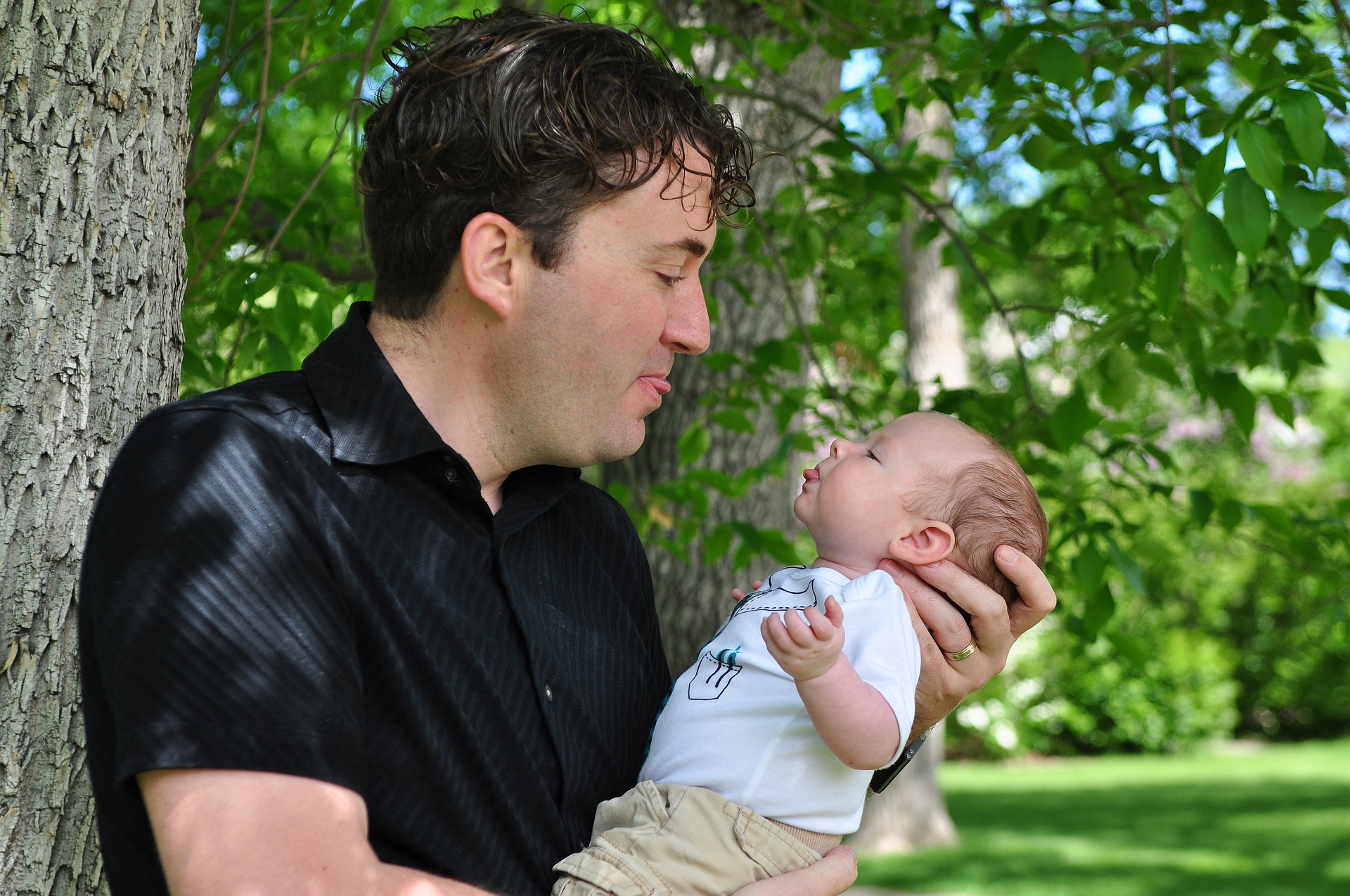 Father and baby smiling