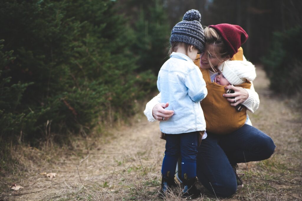 Mother with two small children outside