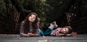 Two people lying down outside