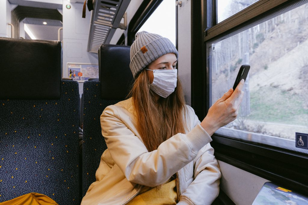 Woman in face mask on train