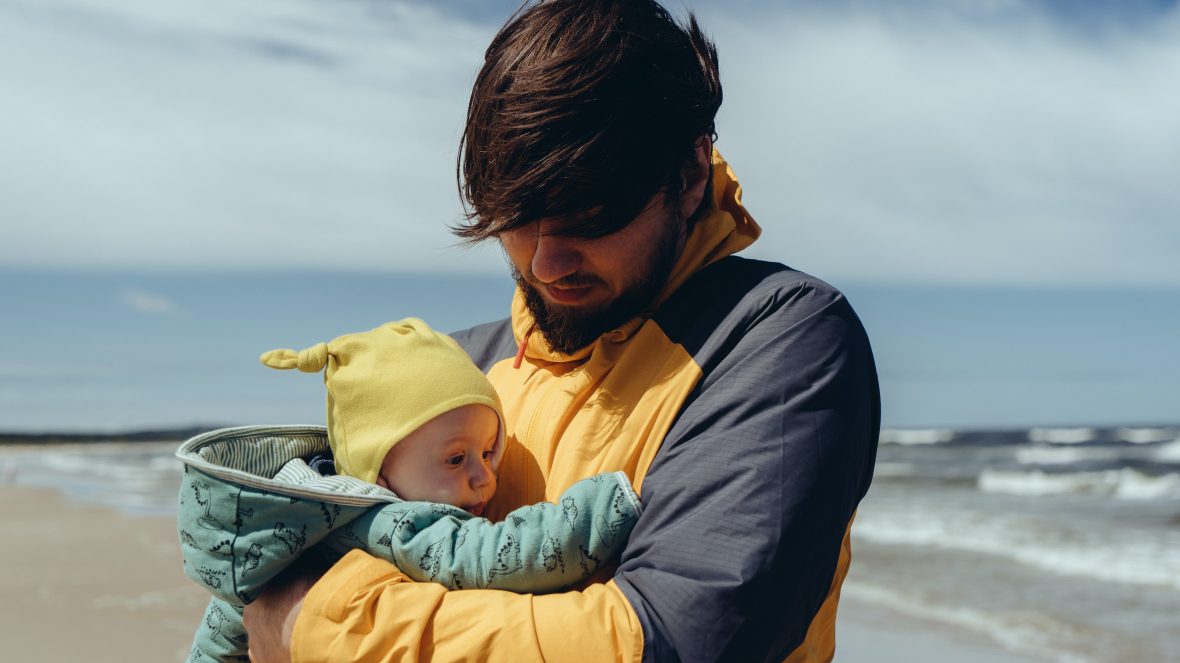 A young father holding his baby