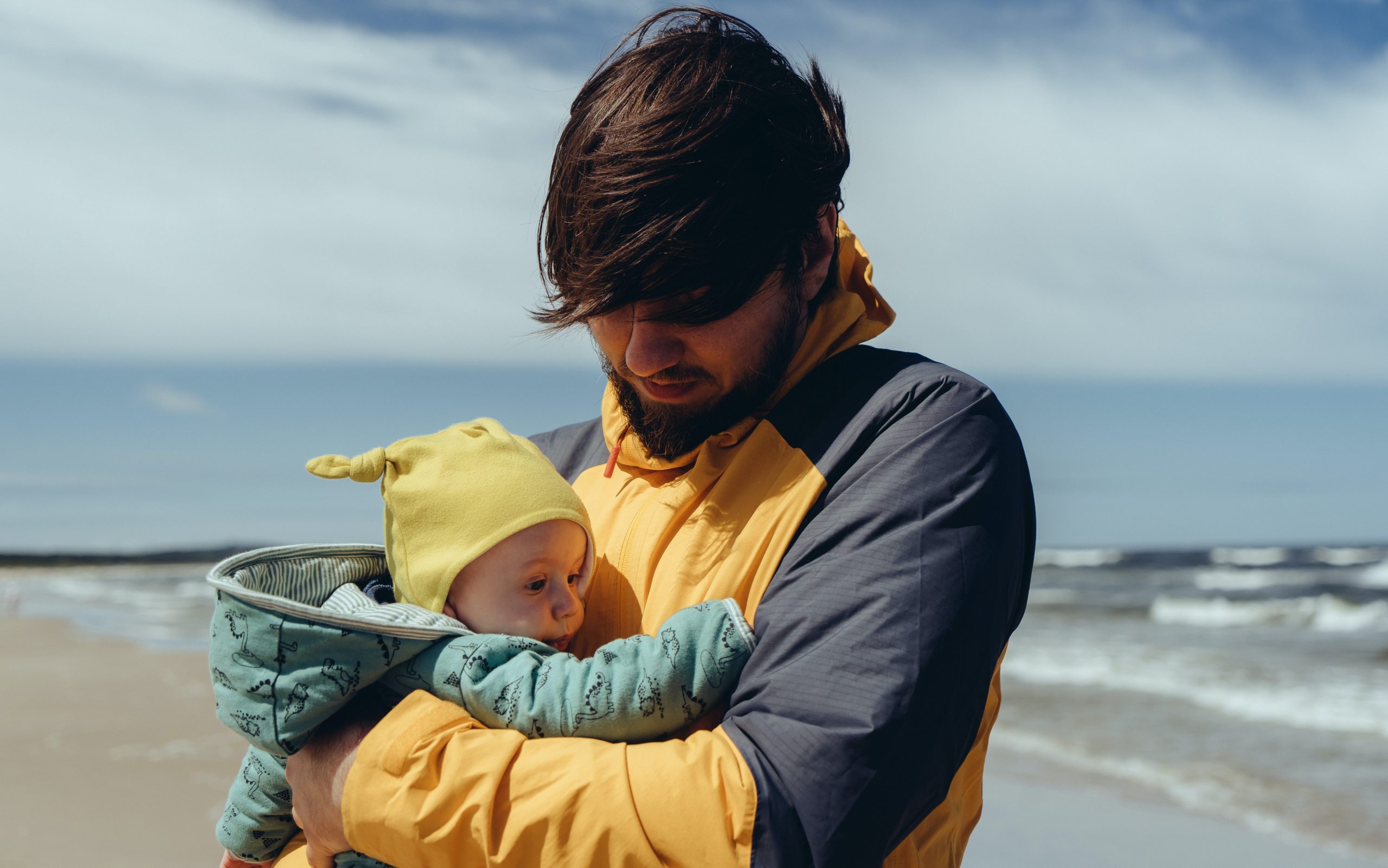 A young father holding his baby