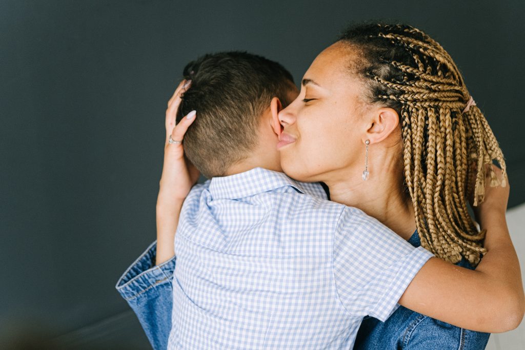 Women hugging a child