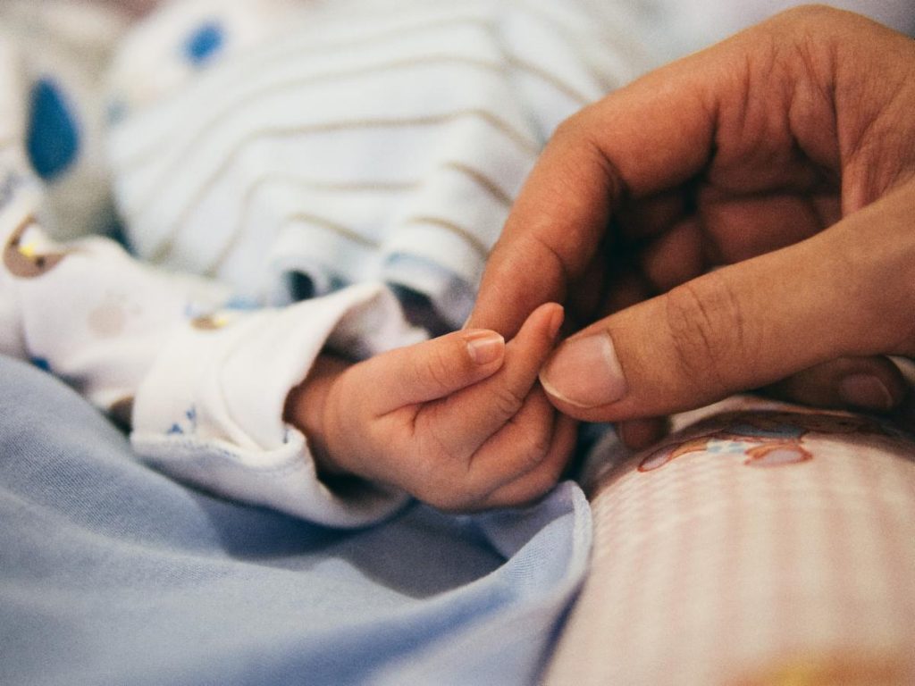 Baby and adult hands