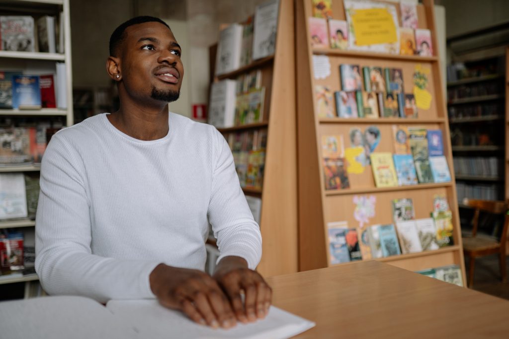 Visually impaired young man reading a book