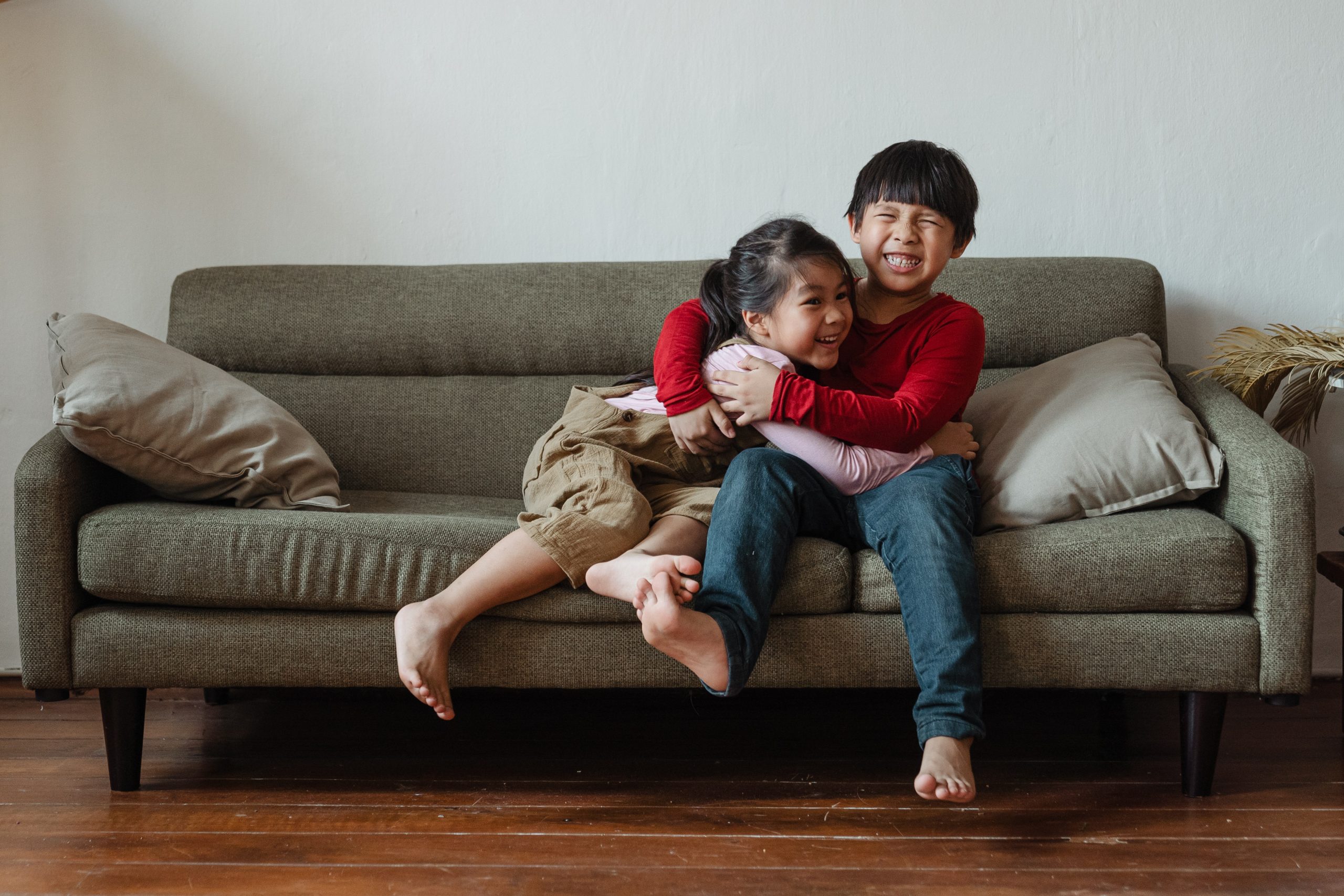 Siblings hugging and smiling