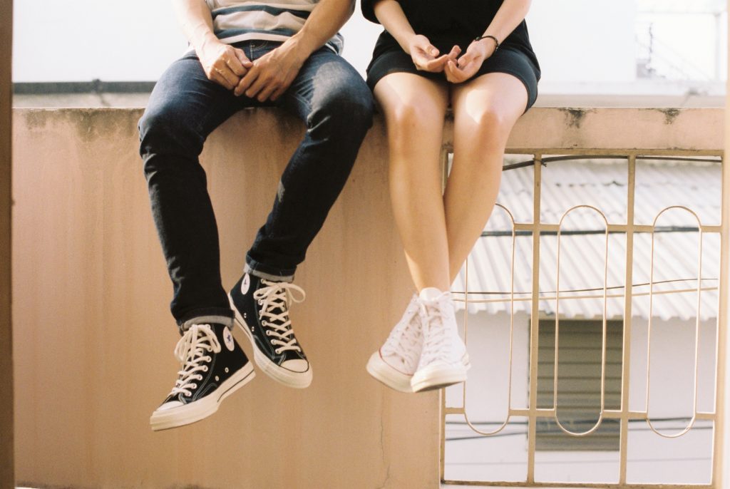 Young people sat on a wall