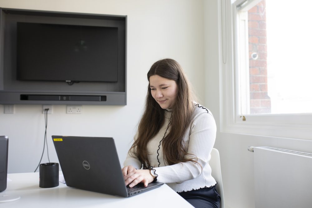 Young woman using a laptop in a desk