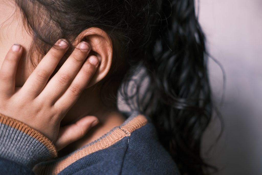 Child covering their ears