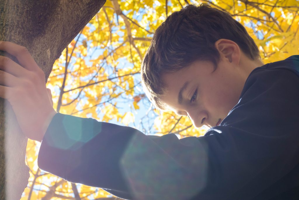 Boy against a tree