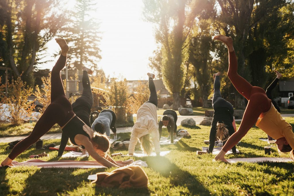 A group of people doing yoga outdoors