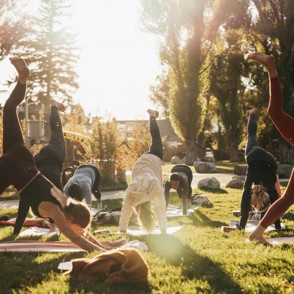 A group of people doing yoga outdoors